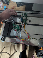 eDP controller board and cables installed inside the gutted iMac shell, connected to the panel ribbon cable
