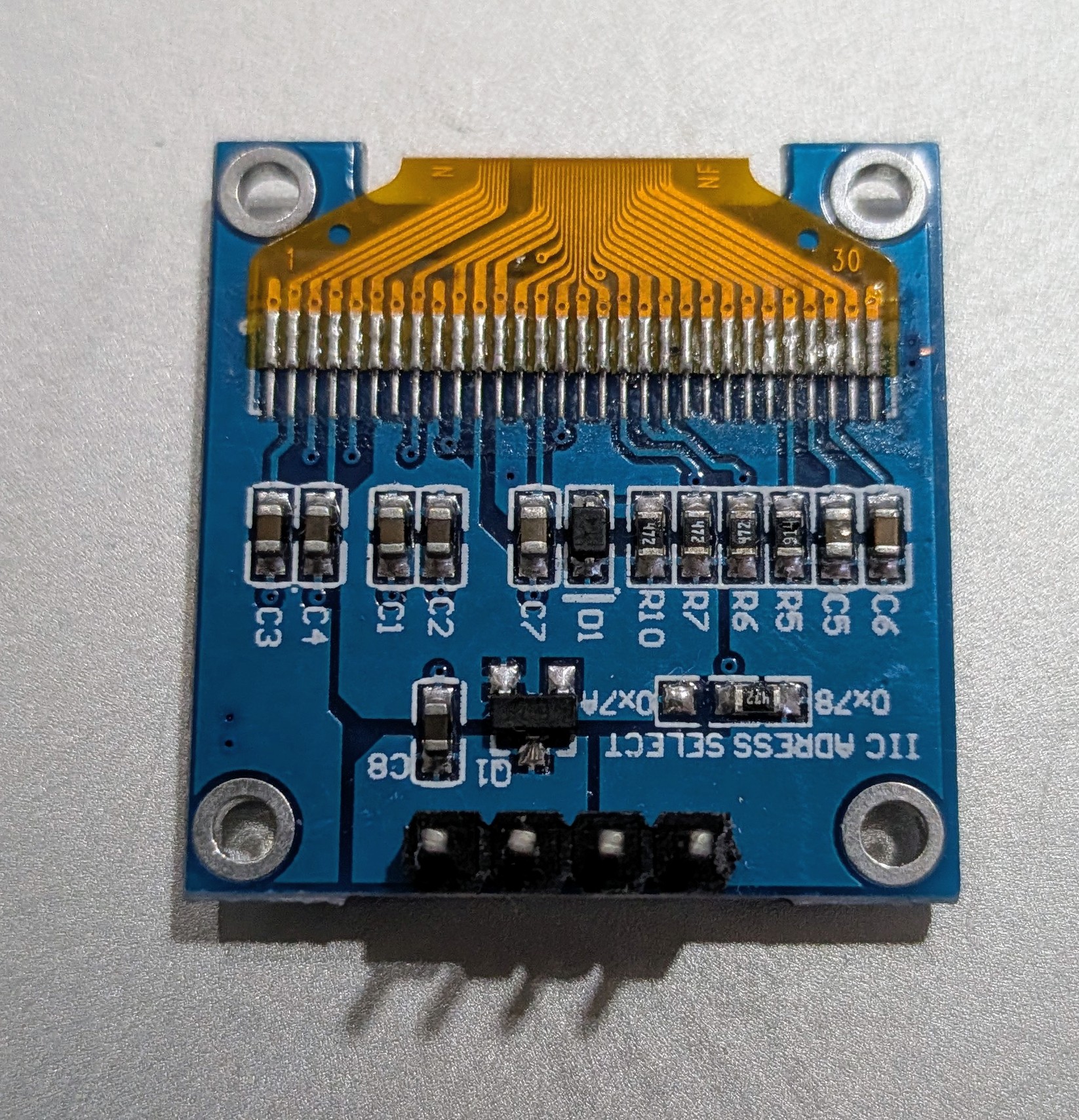 SSD1306 OLED module back showing IIC address select jumper resistors for 0x78 and 0x79